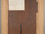 an old picture of a piece of wood with a piece of paper on it