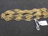 a close up of a gold chain with a tag on it