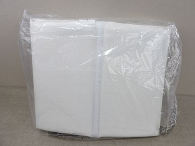 a white napkin wrapped in plastic on top of a table