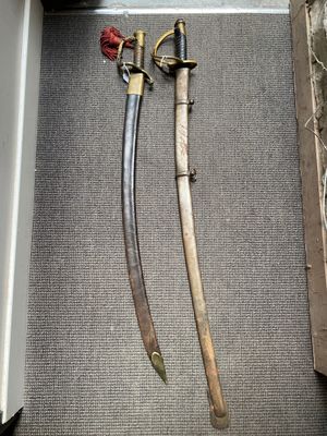 two swords in a box on the floor