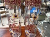 two vases that are sitting on a table