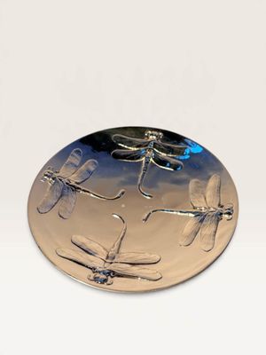 silver plate with dragonflies on it sitting on a white surface