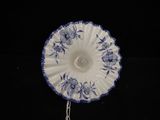 a blue and white plate with a chain attached to it