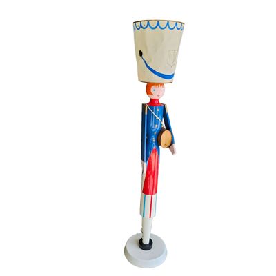 a wooden toy soldier with a hat on it ' s head