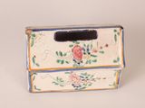 a small box with flowers on it sitting on a table