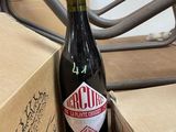 a bottle of beer sitting on a table next to a box