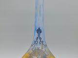 a glass vase with a yellow and blue design on it