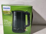 packaging of a black electric kettle sitting on top of a white table