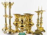 a lot of gold colored candles on a white background