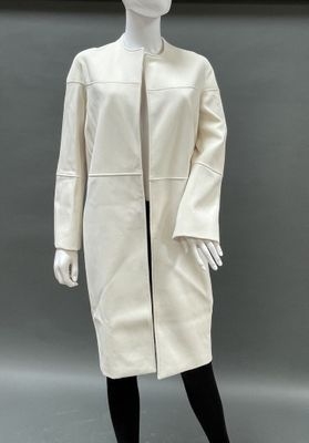 a mannequin wearing a white coat and black tights