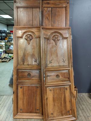 two large wooden doors are stacked on top of each other