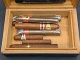five cigars in a wooden box on a table
