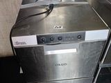a silver dishwasher sitting on the floor in a kitchen