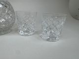 three glasses and a decanter sitting on a table