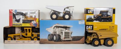 a lot of toy trucks that are sitting on a table