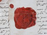 a red wax seal on top of a piece of paper