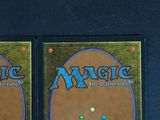 two decks of magic the gathering cards on a black surface