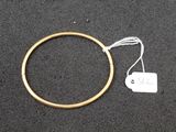 a gold ring with a white tag attached to it