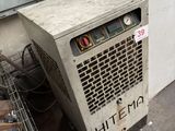 a small air conditioner sitting on the floor next to a wall