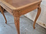 a small table with a wooden top on a cement floor