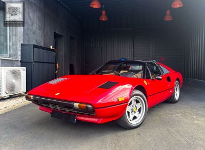 a red sports car parked inside of a garage