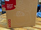 a cardboard box on a table with a mixer in it