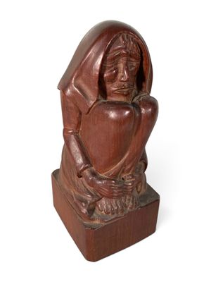 statue of a woman holding a heart on a wooden base