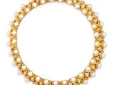 a gold and pearl necklace, by business