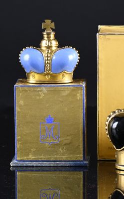 a gold box with a blue crown on it next to a gold box with a blue crown on it