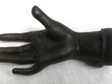 a black glove that is on a white surface
