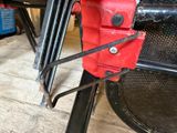 a close up of a red tool holder on a table