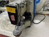 a sewing machine sitting on a table in a factory