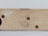 a wooden box with a hole in it on a white surface