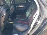 a black car with red trims and black seats