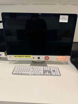 a computer monitor and keyboard on a desk