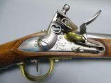 a close up of a gun with a wooden handle on a table