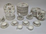 a lot of plates and cups and saucers on the table