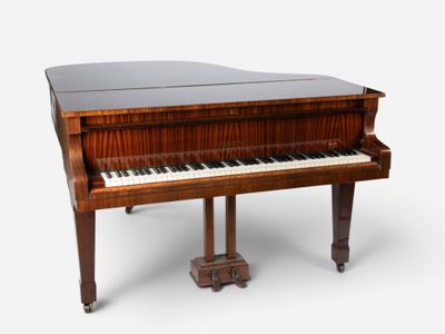 an old grand piano with a wooden case and legs