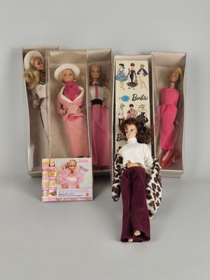 three barbie dolls are in a box and one is sitting on a chair