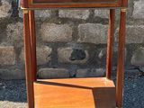 a small wooden table with a drawer on top of it