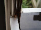 a close up of a window sill with a metal handle