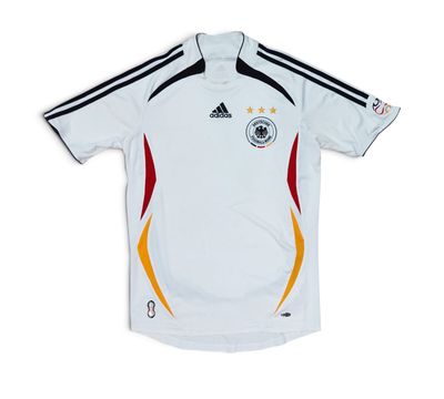 a white soccer jersey with a black and yellow stripe on the chest
