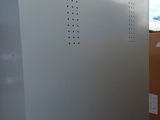 a white box with holes on it sitting in the middle of a room