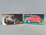 two small boxes of toy cars on a table