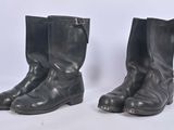 pair of black leather boots on white background with white background