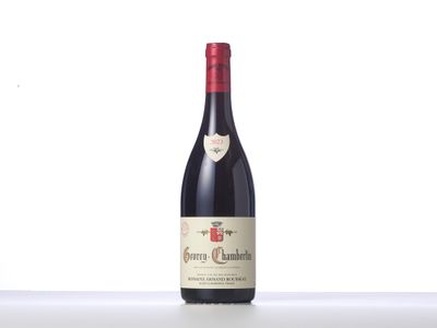 a bottle of red wine sitting on top of a table