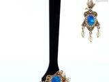 an image of a pair of earrings on a black stand