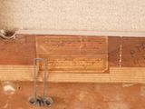 a piece of wood with writing on it next to a pair of scissors