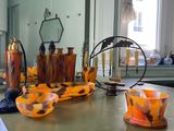 many vases and bowls on the table in the room