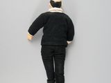 a doll that is laying down on a white surface